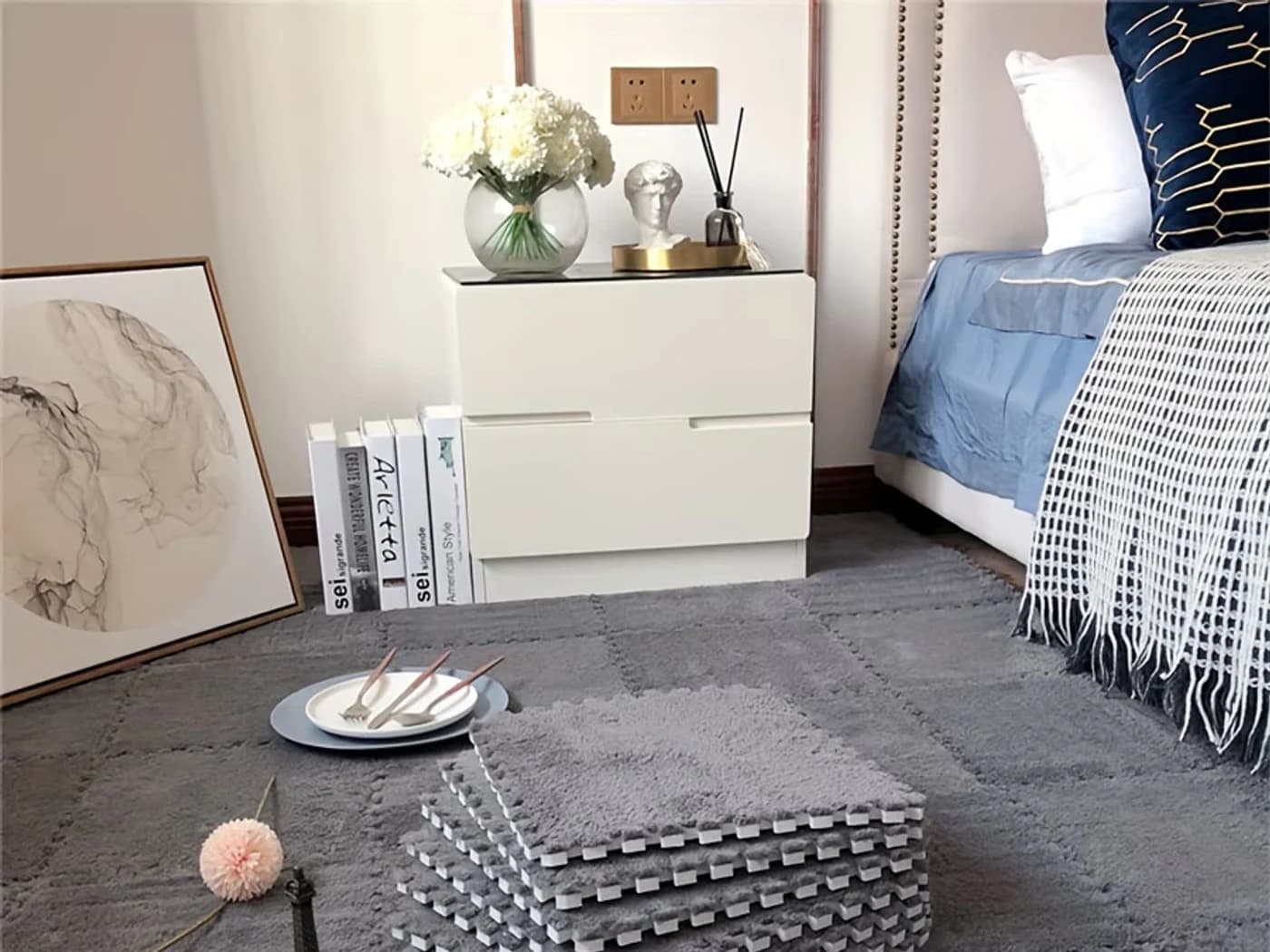 Gray modular rug for home decor supply Gray modular home decor rug arranged in a furnished bedroom.